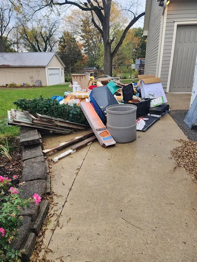 Dumpster being loaded with debris for Commercial Dumpster Rental in Florissant